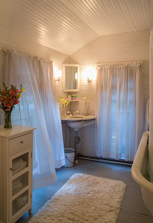 Country bathroom with curtains blowing in the breeze