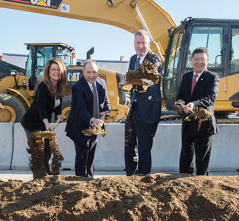 Four officials with shovels tossing dirt at Pacific Park Ground Breaking