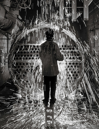 Welder dismantling boiler