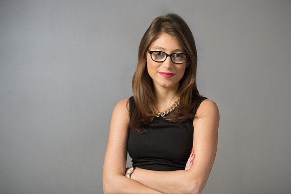 Portrait of young woman wearing glasses and black sleeveless top