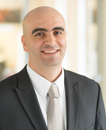 Portrait of man with shaven head wearing grey suit