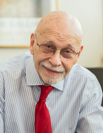 Dr. Steven Goldstein wearing white shirt and red tie