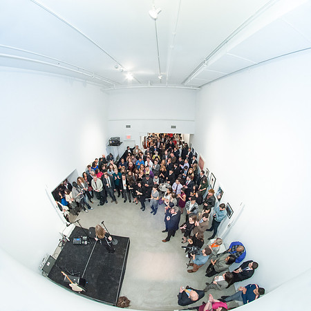 Fisheye view of crowd in white room at re:FORM Art Auction