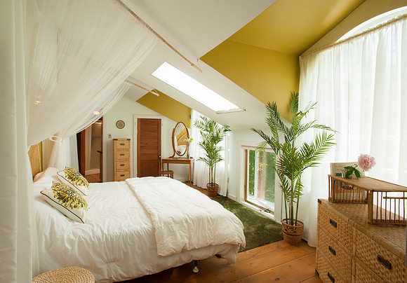 Bedroom, bed on left facing right toward curtained window.