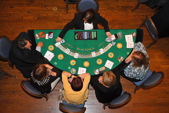 Overhead view of casino table and players.