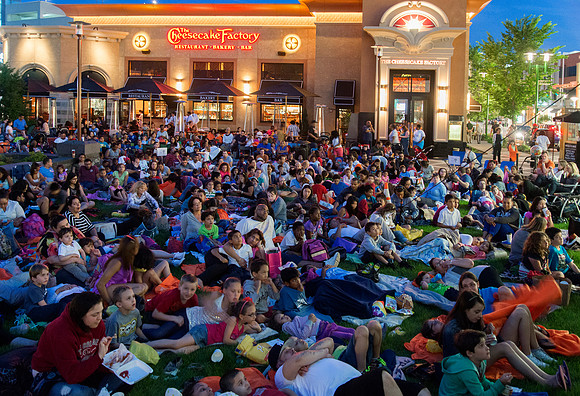 Crowd on lawn in front of restaurant waiting for Movie Night on the Lawn at Ridge Hill Mall