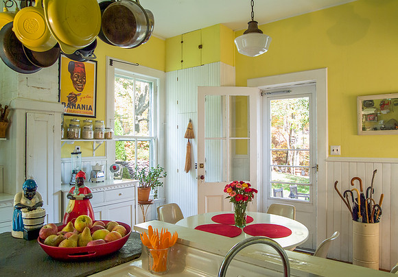 Country kitchen decorated with Black memorabilia and pots hanging in corner