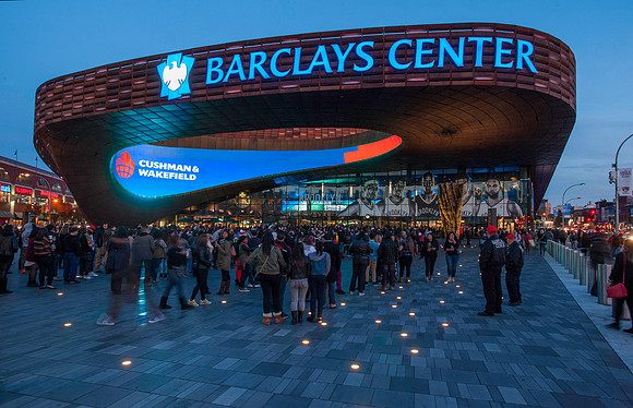 Barclays Center, Brooklyn NY at dusk with lines of fans waiting