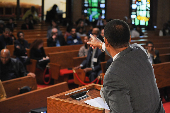 Speaker at podium in church at the Conference on Reducing Crime and Incarceration